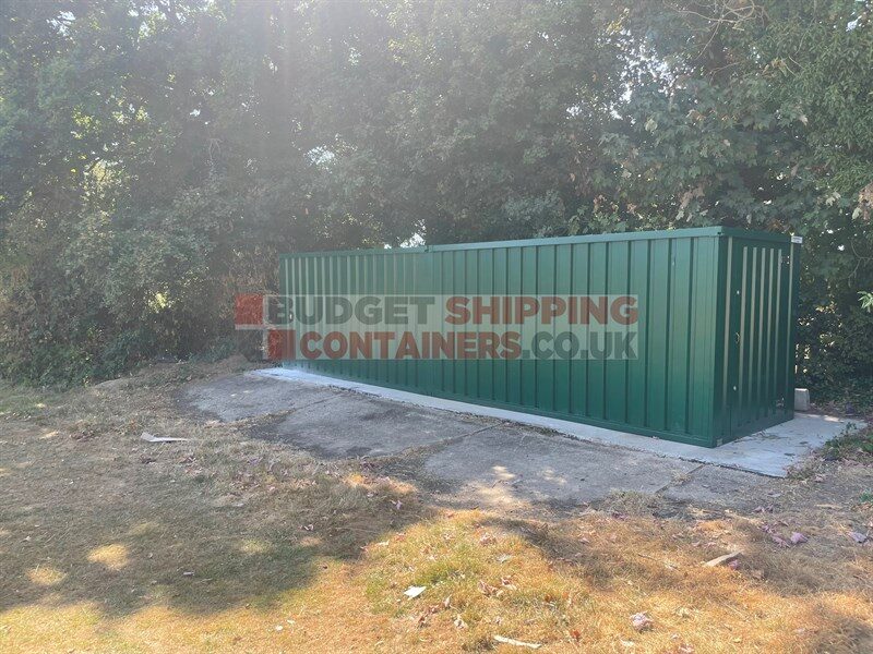 side view of 8am long storage container next to woodland