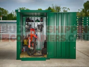 Open door of motorbike storage unit, with view of motorbike and shelving inside