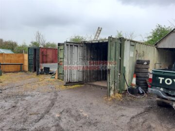 old green shipping cotnianer still being used for storage effectivly