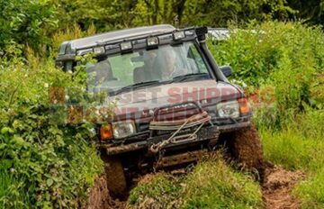 4x4 offroading through a muddy, overgrown field