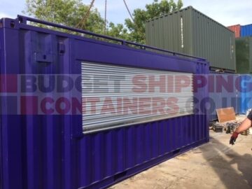 Purple repainted shipping container with roller shutter