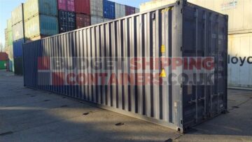 Side view of a nearly new 40ft shipping container in Blue, showing neat and tidy sides with some minor grime but no obvious dents