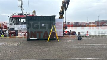 Lab container with personnel door and window sitting on a dock yard
