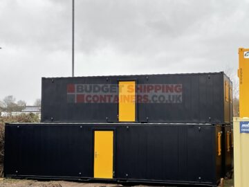 32ft cabins painted in black externally with yellow security windows and doors