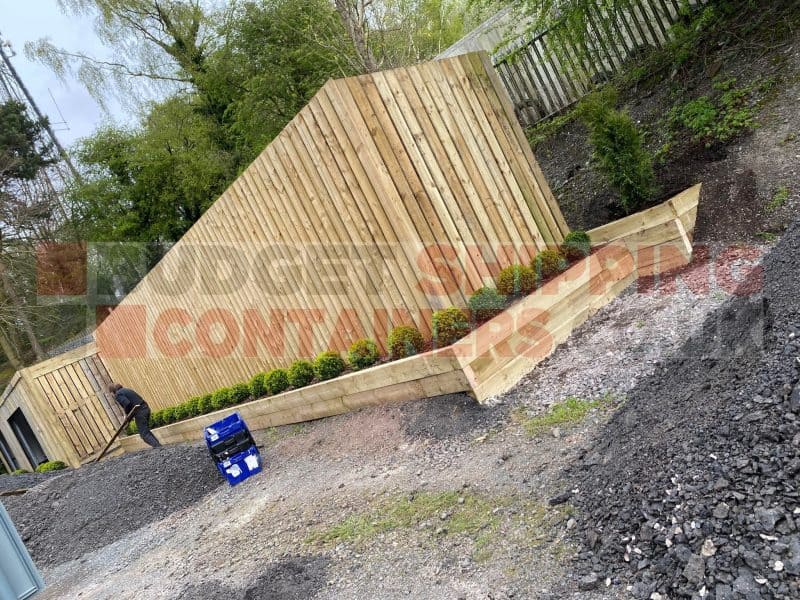 Timber cladding around a 40ft shipping container on a driveway