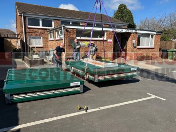 flat packed units being offloaded via crane
