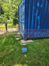 Laying the container onto slabs making sure it is level.