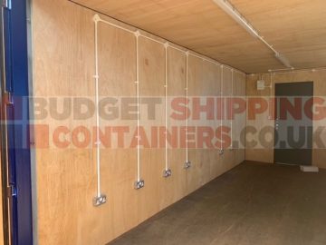 Refurbished container with plywood lining, plug sockets and lighting