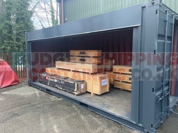20ft Refurbished shipping container in grey with electric roller shutter loaded with crates