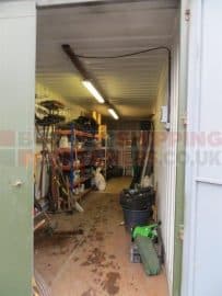 inside a 30ft shipping container being used for storage. electrics fitted, shelves full of general goods