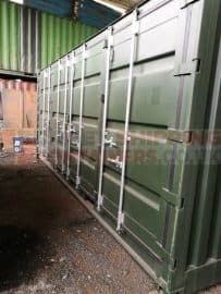 Side opening container that has been repainted green with masked locking bars