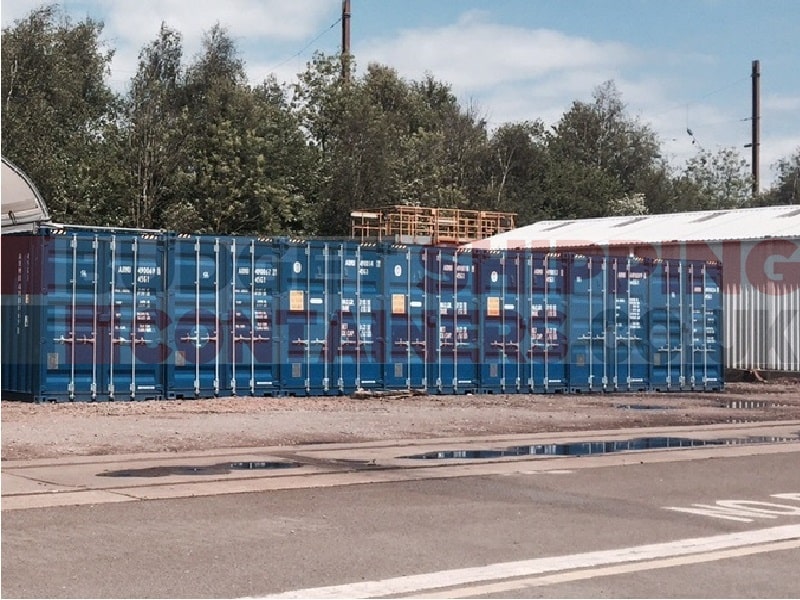 row of blue 40ft high cube shipping containers at customers site