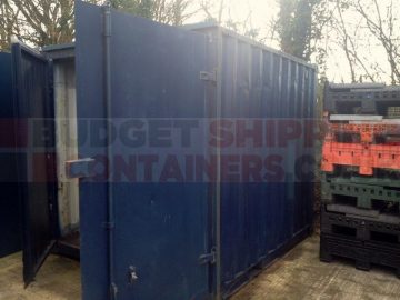 door and side pannel view of 10ft refrubsihed container. doors open, dents visible on side panel
